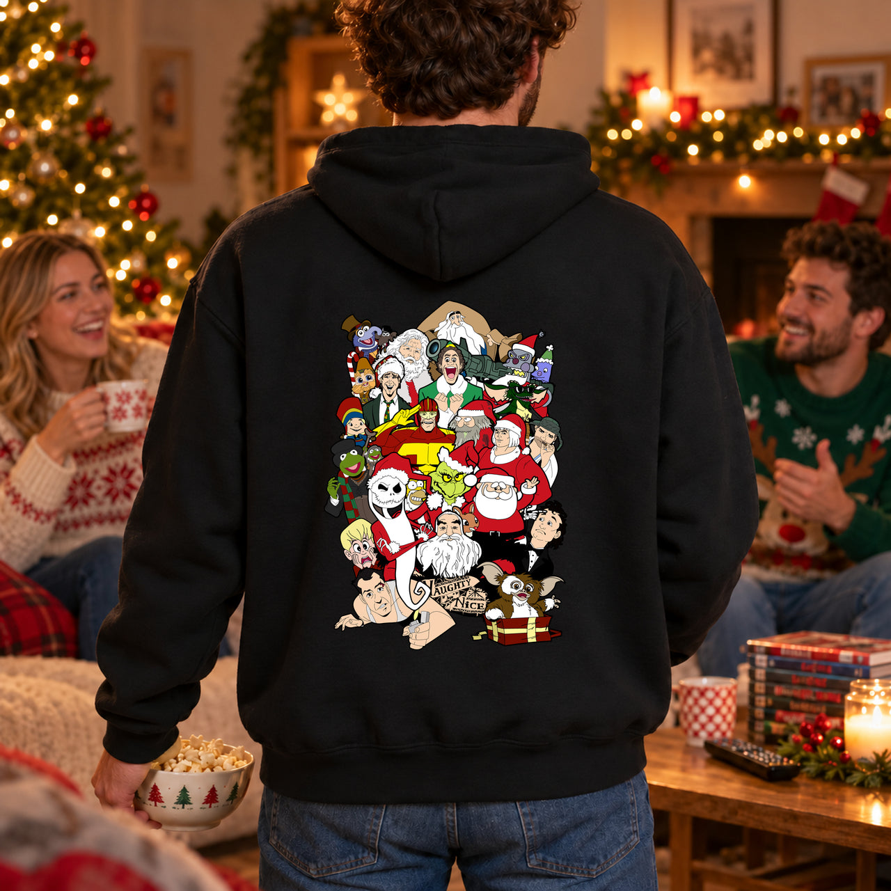 Adult wearing a black Christmas Chaos back-print hoodie, viewed from behind at a Christmas film night with friends